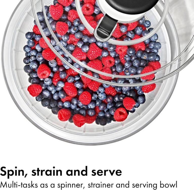 Top view of OXO salad spinner filled with blueberries and raspberries used as spin, strain and serving bowl