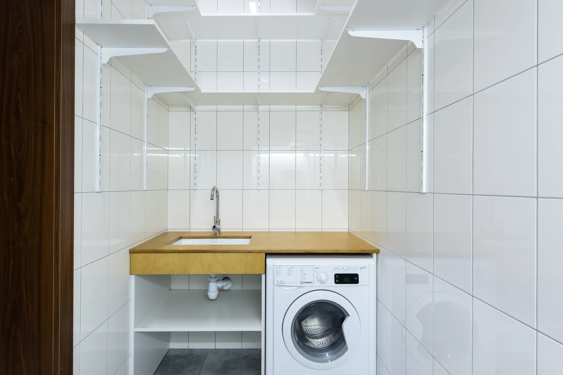 Wall mounted shelves in a small laundry room