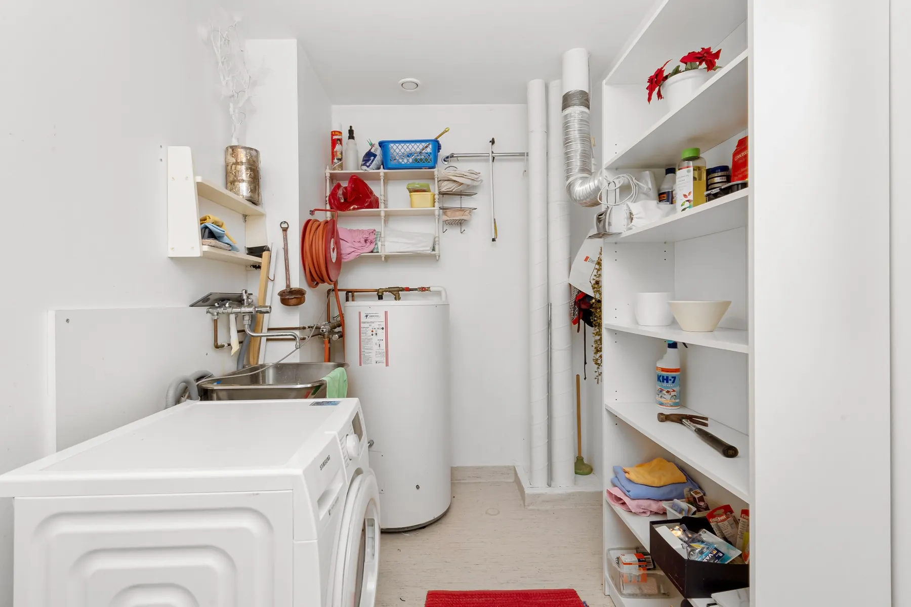 Laundry room with organized wall shelving