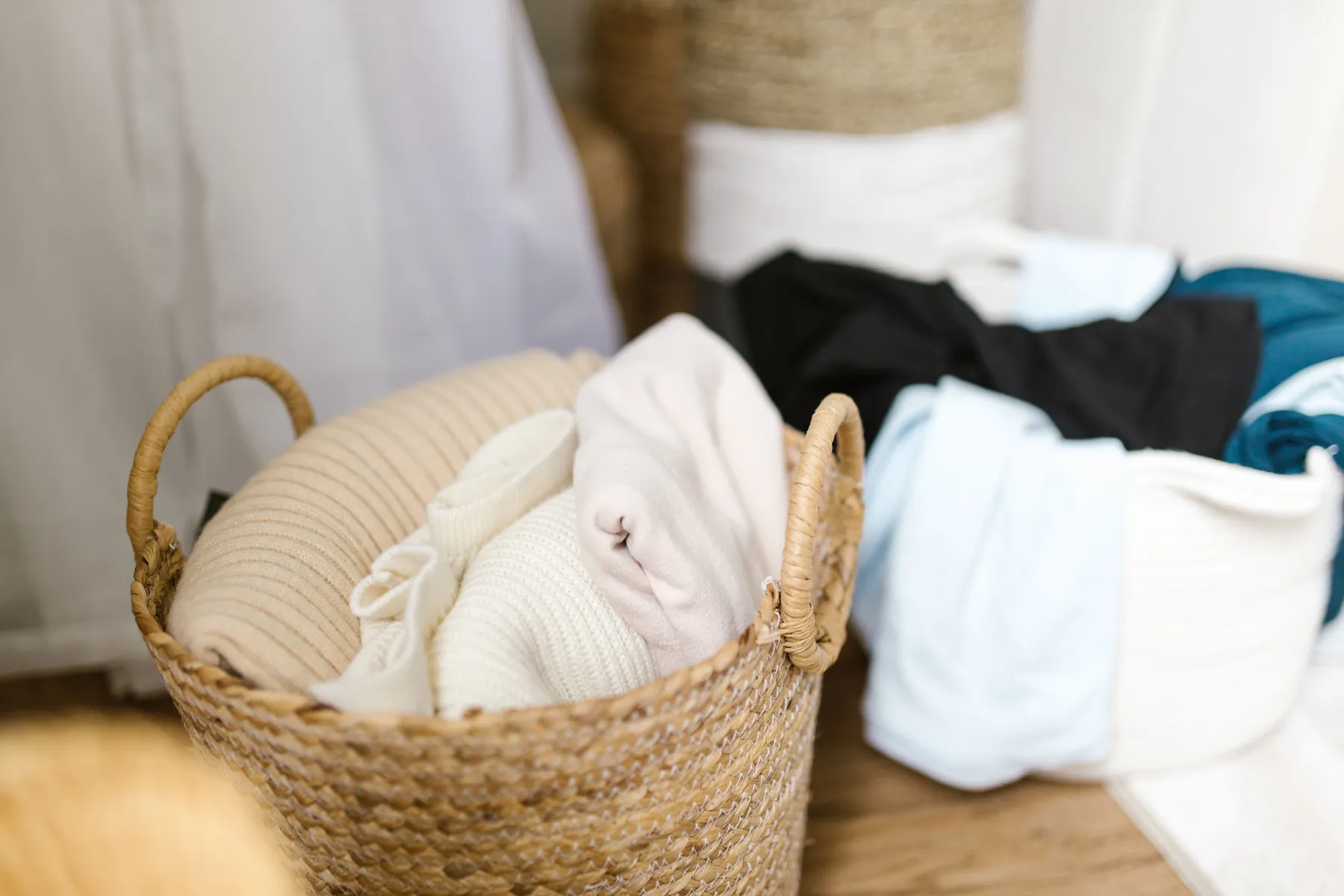 Neatly organized clothes in woven laundry baskets